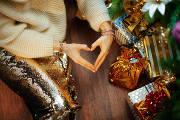 elegant 40 year old woman showing heart shaped hands