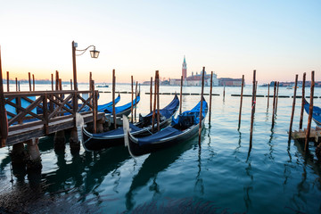 Sunrise at Venice with gondola and island of st george view from the square San marco