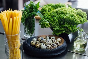 Close up photo. Italian pasta on table, eggs in plate, healthy food concept. Ingredient for spaghetti preparing.