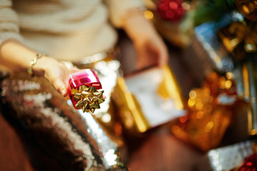 stylish woman holding present box and facial cream