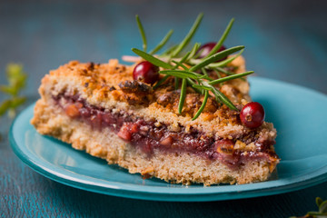 Grated cake with a jam on a blue plate