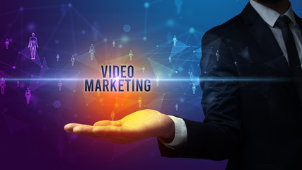 Elegant hand holding VIDEO MARKETING inscription, social networking concept