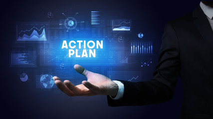 Hand of Businessman holding ACTION PLAN inscription, business success concept