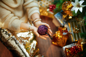 elegant housewife showing purple Christmas ball