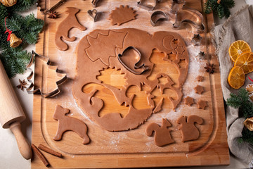 Cutting out pastry shapes for gingerbread Christmas cookies