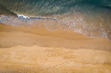 Aerial view of merry Christmas drawn in sand