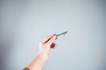 woman hand holding vintage key