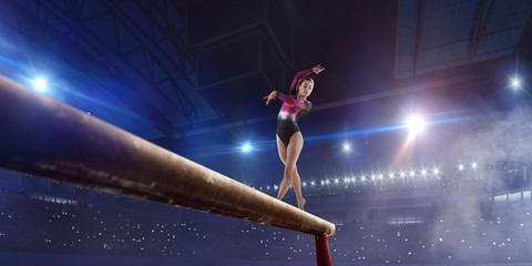 Female gymnast on professional arena.