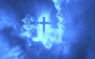 Christian cross appears bright in the dark blue sky