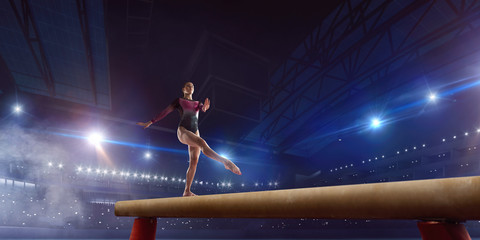 Female gymnast on professional arena.