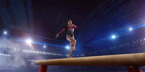 Female gymnast on professional arena. - obrazy, fototapety, plakaty