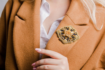 Beautiful brooch in the shape of medal, close-up