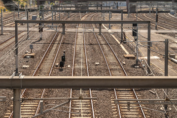 Melbourne, Australia - November 15, 2009: Brown environment of train tracks, metal beams and electrical lines outside Flinders Street Railway Station.