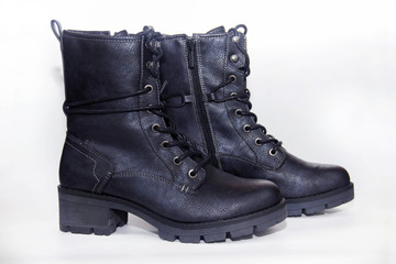 Black shoes with laces on a white background. Isolate.Black army shoes isolated on a white background. Black army shoes