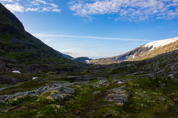 Nice view in the mountains. At the top of the mountains lies snow