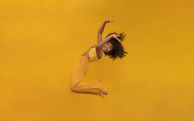 Side view of afro hair woman in zero gravity or a fall. Girl is flying, falling or floating in the...