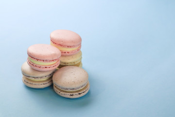 Tasty sweet macaron cakes on color background