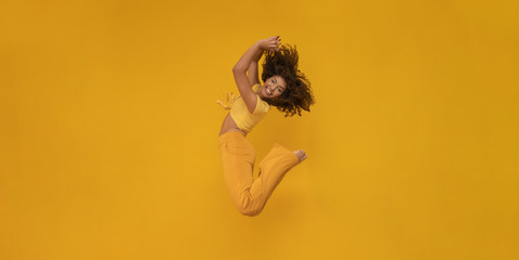 Side view of afro hair woman in zero gravity or a fall. Girl is flying, falling or floating in the...