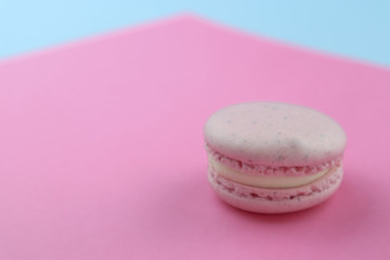 Tasty macaron on color background
