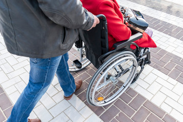 Volunteer social worker helps for disabled people and elderly people. Old woman in a wheelchair....