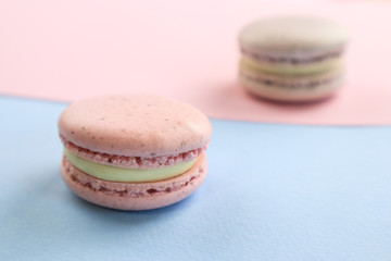 Tasty sweet macaron cakes on color background