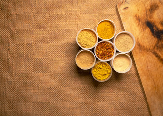 Top view mix spices and herbs different on sackcloth background with copy space for design healthy lifestyle, spices, herbs or foods and  massage aromatherapy content.
