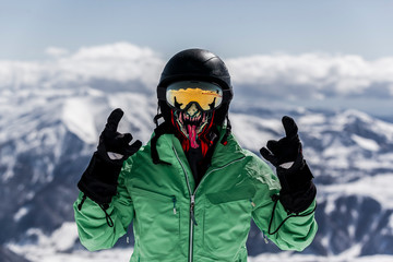 Fototapeta na wymiar Skier in mask enjoying winter vacation.
