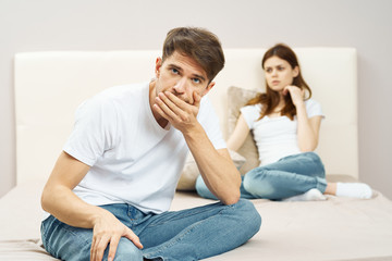 Fototapeta na wymiar young couple sitting on sofa watching tv