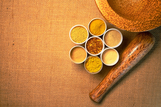Top view mix spices and herbs different on sackcloth background with copy space for design healthy lifestyle, spices, herbs or foods and  massage aromatherapy content.