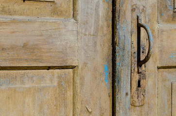 vintage. old wooden door and rusty iron knocker. close-up