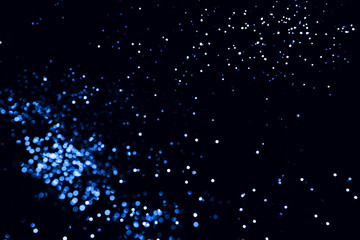 Blue abstract bokeh on black background. Holiday concept