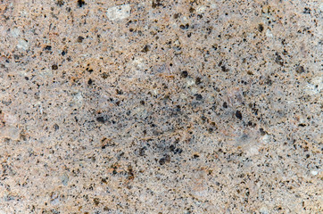 Granite background. The wall of the old building. Close-up.