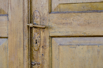 vintage. old wooden door and rusty iron door knob. close-up