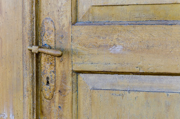 vintage. old wooden door and rusty iron door knob. close-up