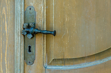 vintage. old wooden door and rusty iron door knob. close-up