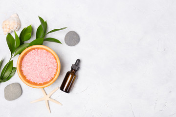 Beauty and spa concept. Sea salt, oil, stones, green leaves and shells on white background. Flat...
