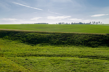 autumn landscape. field on a sunny day..Pattern of airplane trails of condensed air crisscrossing each