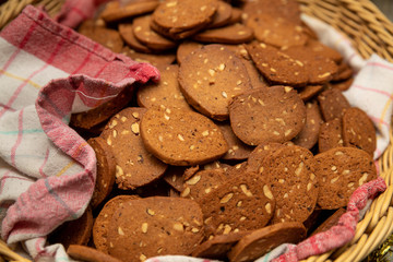 Homemade Gingerbread with almonds and a red checked towel in a basket