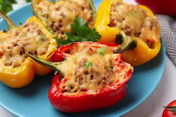 Tasty stuffed bell peppers on table, closeup