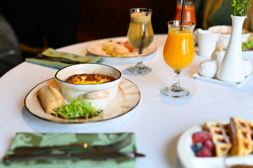 morning Breakfast or brunch in the restaurant. table with drinks and food. plate with delicious Viennese waffles. selective focus