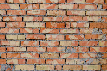 Fototapeta premium Old brick wall, old texture of red and orange blocks of stone. Closeup