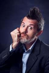 A portrait of bearded man with iroquois wearing suit