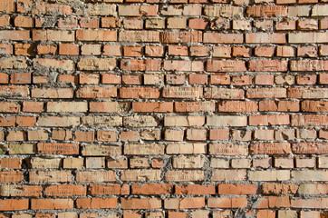 Obraz premium Old brick wall, old texture of red and orange blocks of stone. Closeup
