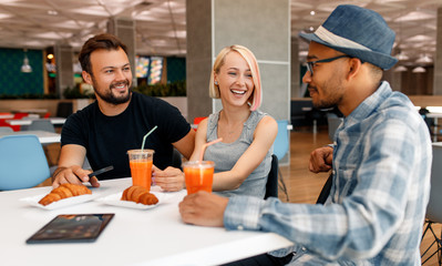 Multiethnic colleagues talking in cafe