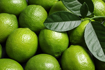 Fresh ripe green limes as background, closeup