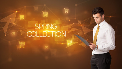 Businessman with shopping cart icons and SPRING COLLECTION inscription, online shopping concept