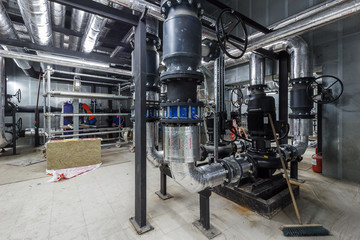 pumping station under construction. pipes of central heating system and water pipes with thermal...