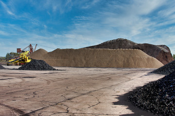 Heaps of coal. Coal loading excavator
