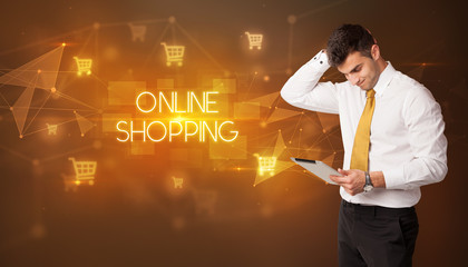 Businessman with shopping cart icons and ONLINE SHOPPING inscription, online shopping concept