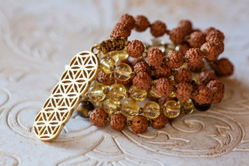 Spiritual mala bead necklace with natural mineral stone beads on wooden decorative background